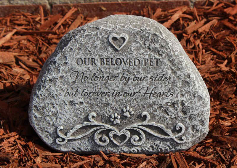 Memorial stone engraved for a beloved pet in mulch