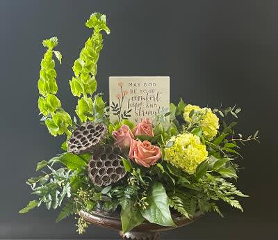 Arrangement of pink roses and yellow flowers with tall green blooms in a vase
