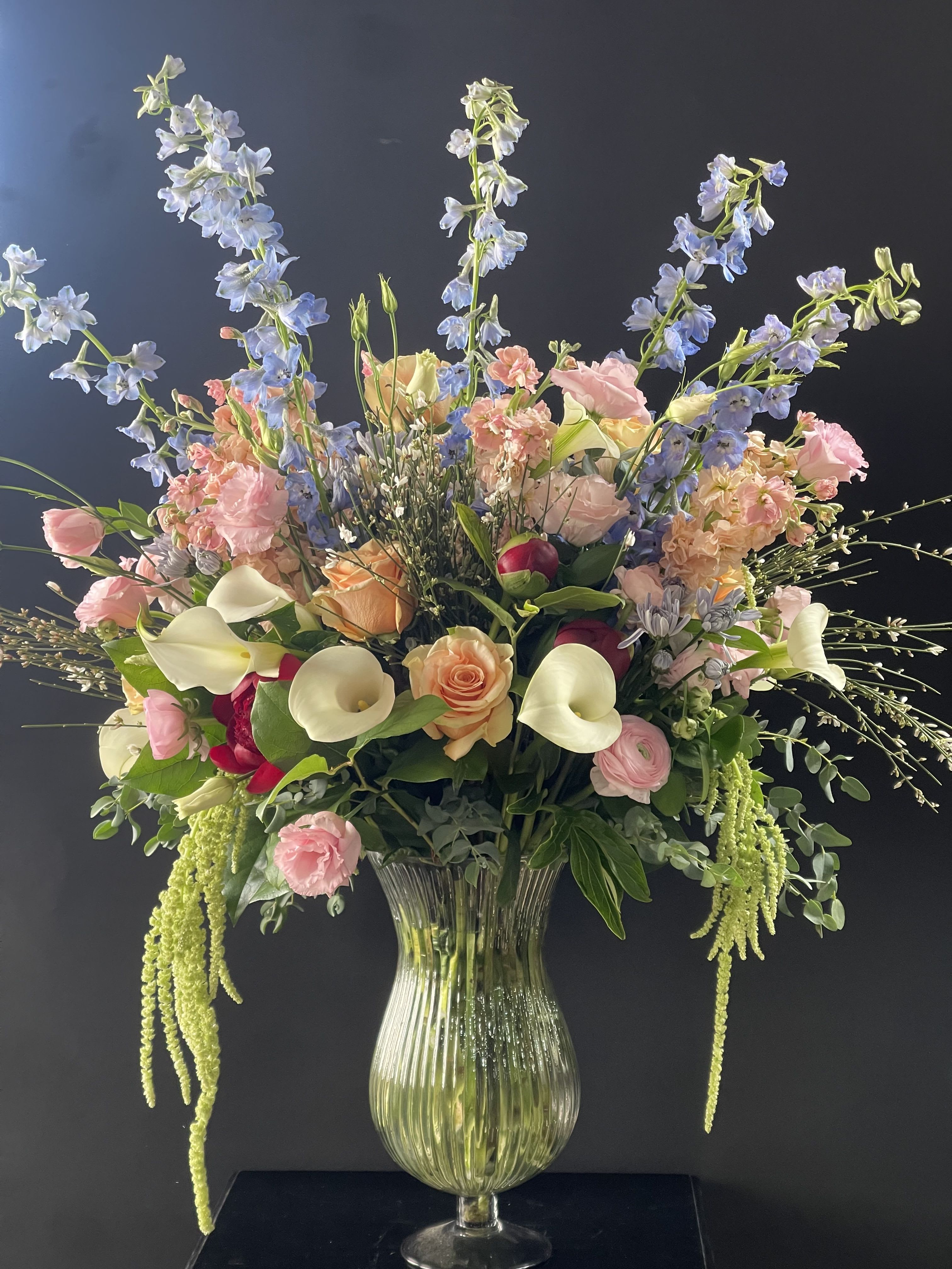 Large pastel floral arrangement in a clear glass vase