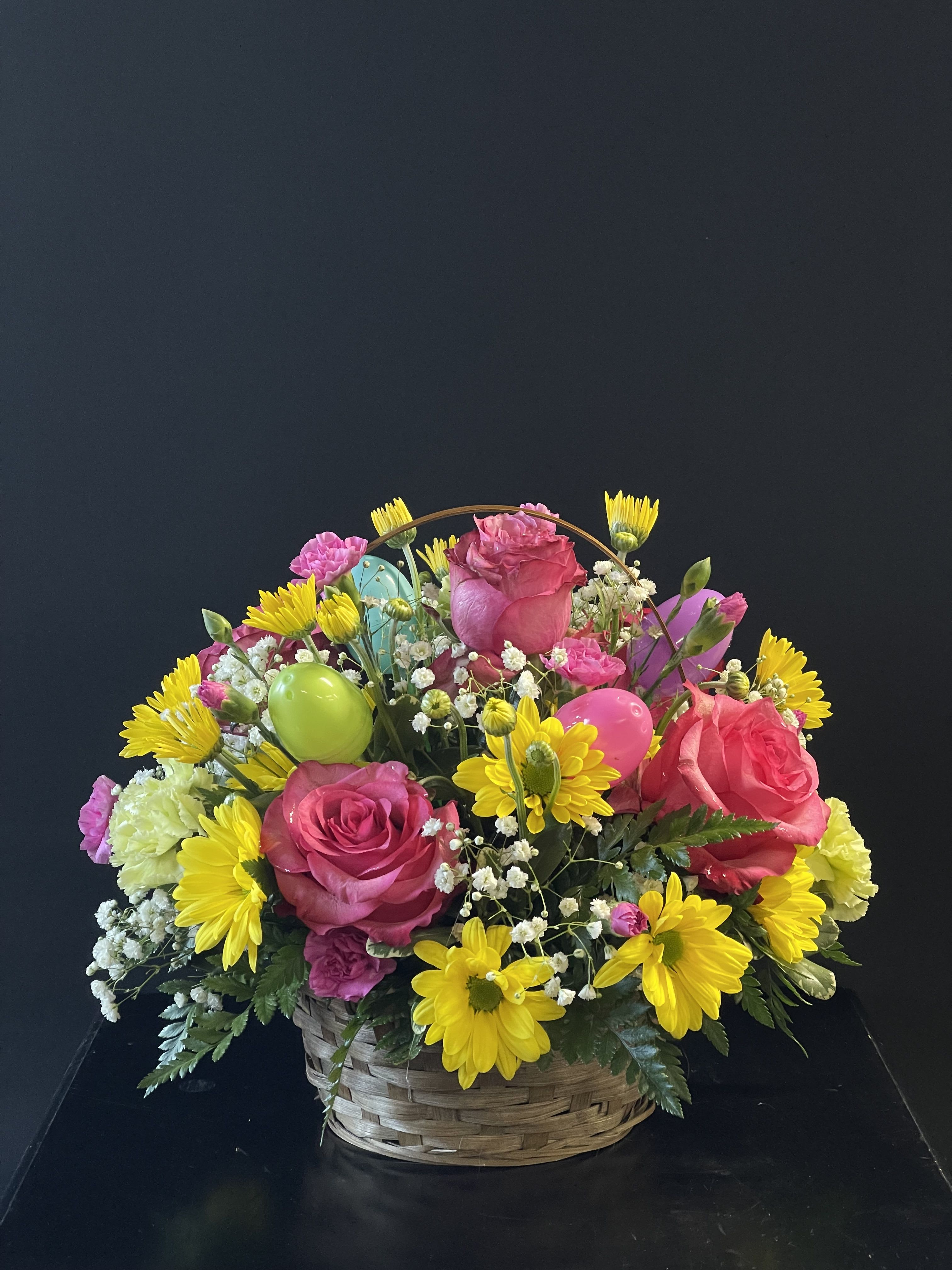 Basket arrangement of pink roses and yellow daisies with colorful balloons