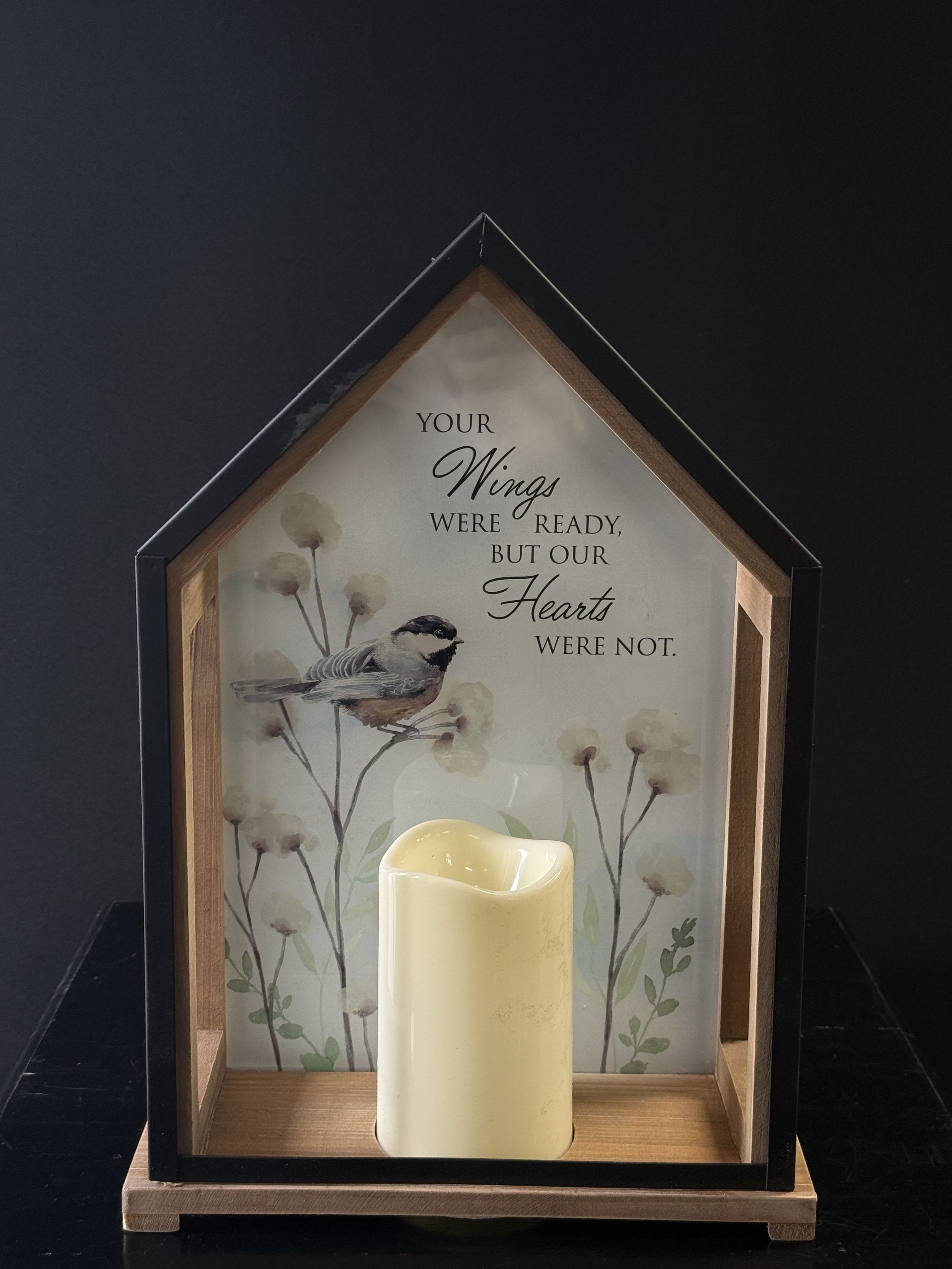 House-shaped memorial frame with a candle and bird illustration