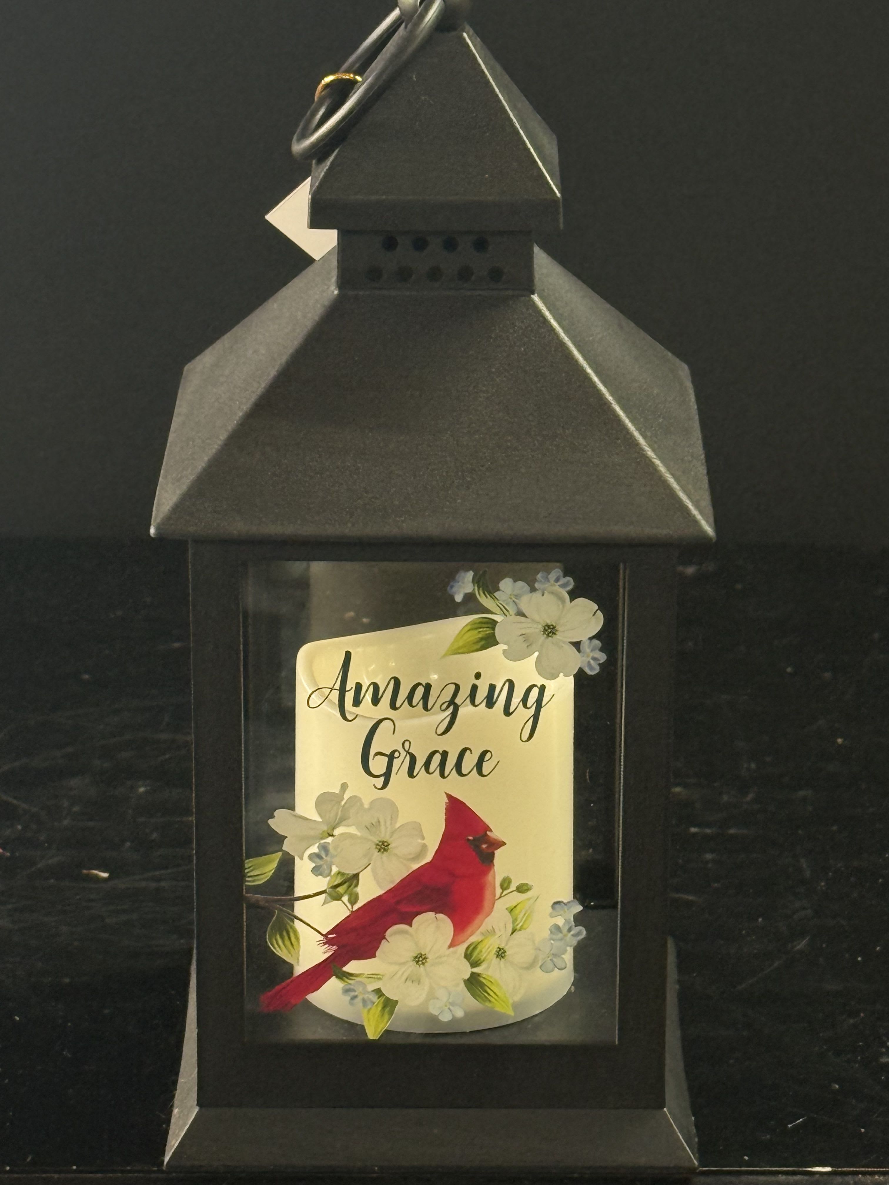 Black lantern with a cardinal and floral design reading "Amazing Grace"