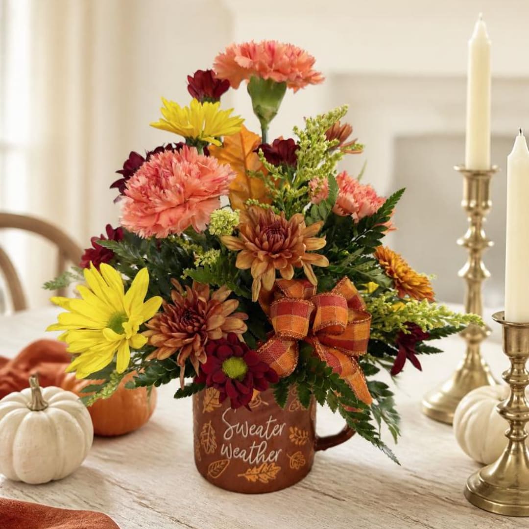 Fall flower arrangement in a mug with yellow and orange blooms
