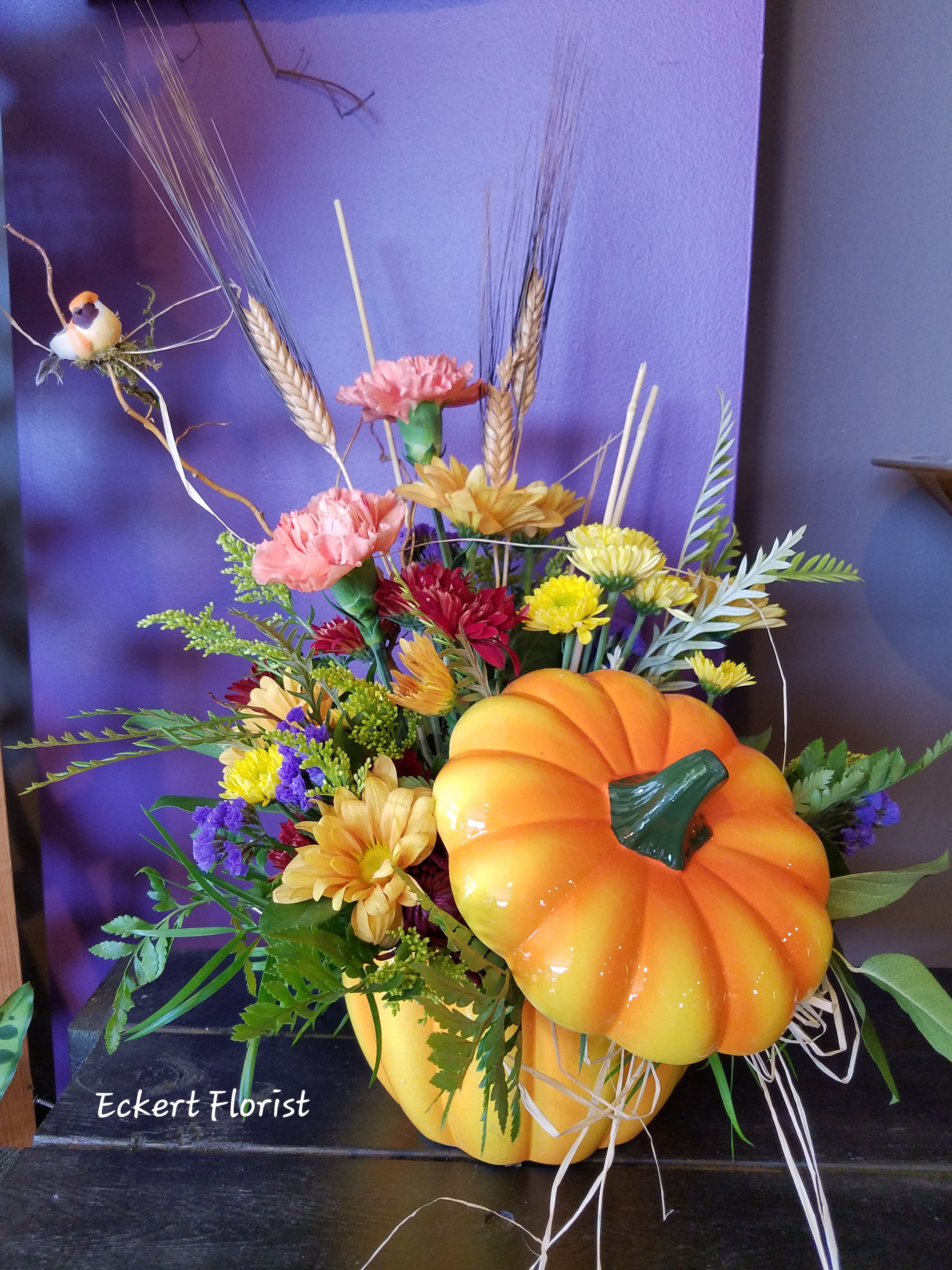 Eckert Florist's It's The Great Pumpkin Bouquet *LOCAL DELIVERY ONLY - Want to say "Happy Autumn!"? This is the arrangement for you! Seasonal colored blooms are arranged to perfection within a keepsake lidded ceramic pumpkin container. *Flowers and colors may vary.
