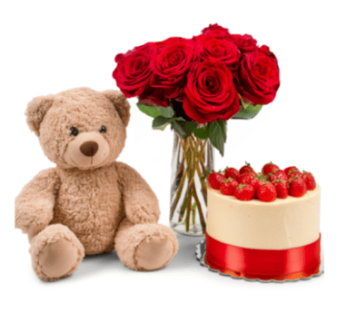 Red roses in a glass vase beside a teddy bear and strawberry cake