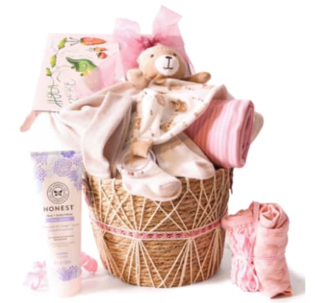 LITTLE PRINCESS-CANASTA WITH BABY SUPPLIES - Soft blush pinks, creamy whites, and gentle peaches come together in this Little Princess baby gift basket-a perfect baby shower or new baby gift that will make the new little one's world feel warm and cherished. Designed to delight the new parents and comfort the baby, the arrangement reads like a cozy nursery vignette topped with a cuddly teddy bear and finished with a cheerful ribbon and greeting card.  Arranged in a woven wicker basket, this gift includes folded baby blankets, a baby outfit and socks, a baby care bottle and lotion tube, and other soft essentials layered among tissue and gift wrap for a polished presentation. The mix of plush textures, natural basket weave, and pastel florals gives a sweet, tactile look that's as attractive on a gift table as it is practical for everyday use.  This is the kind of present that helps new parents feel supported and celebrated-ideal for baby showers, hospital visits, or welcoming a newborn home. Sizes and exact contents are arranged to present beautifully and arrive ready to give; include a personalized greeting card message at checkout to make the moment truly personal.