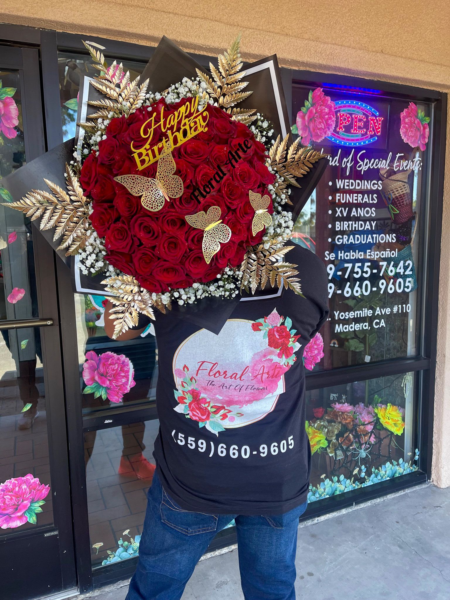 Large red rose bouquet with gold butterfly accents and a Happy Birthday sign