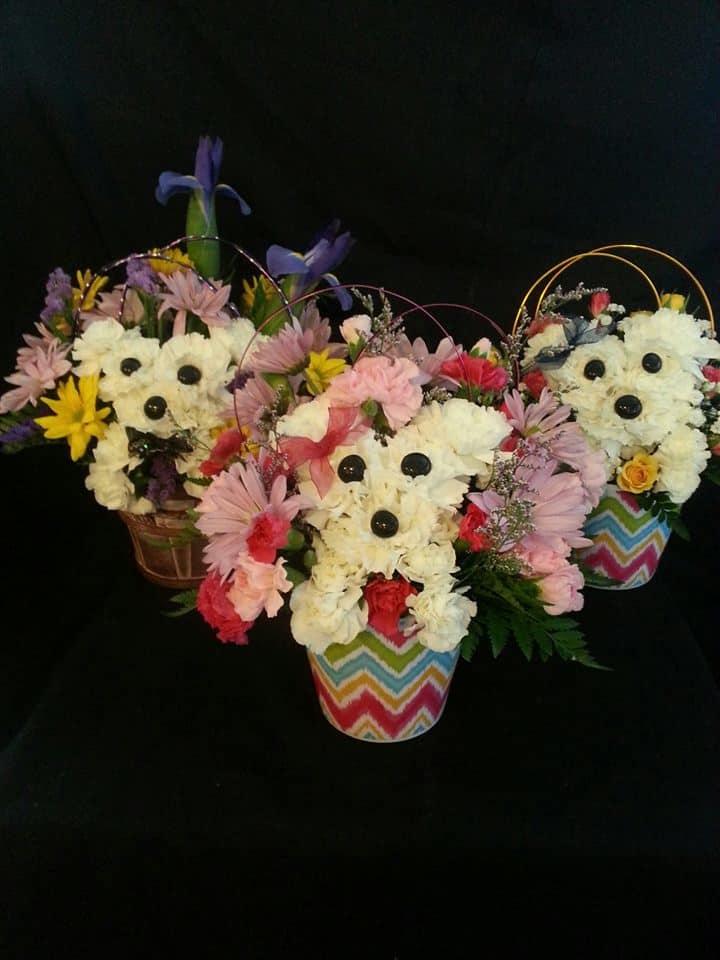Flower baskets arranged as teddy bears with colorful blooms and striped pots