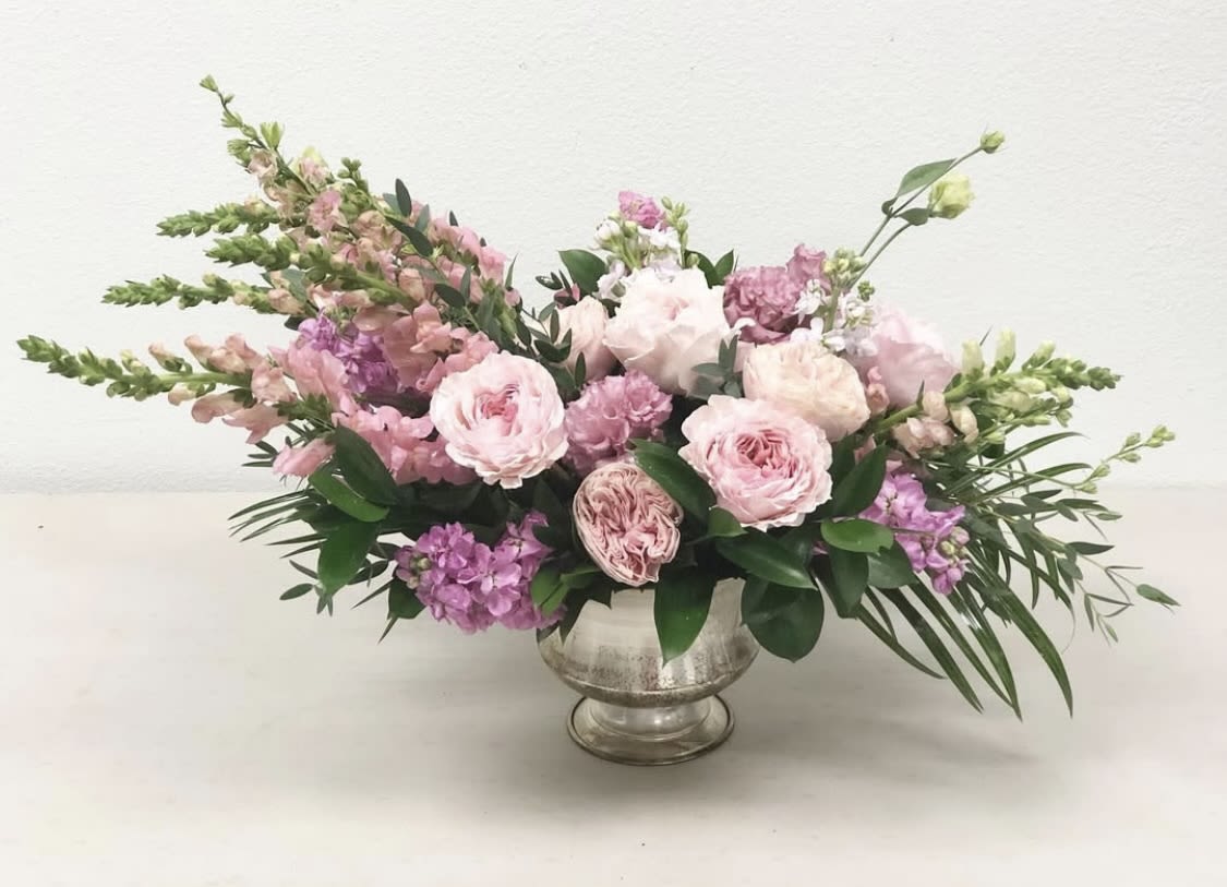 Pink and lavender floral arrangement in a silver vase