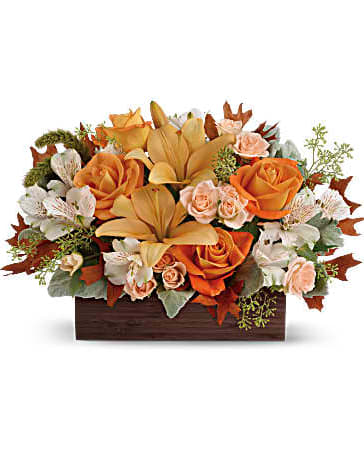 Fall Chic Bouquet - Simply chic and overflowing with fall blooms! This gorgeous arrangement is sure to impress with its glorious shades of autumn - combining orange roses, peach lilies and seasonal brown leaves. Hand-delivered in a dark-toned bamboo rectangle. This impressive arrangement features light orange and peach roses, peach asiatic lilies and white alstroemeria, and finished with dusty miller, seeded eucalyptus and millet. Delivered in Teleflora's Dark Bamboo Rectangle. Orientation: All-Around