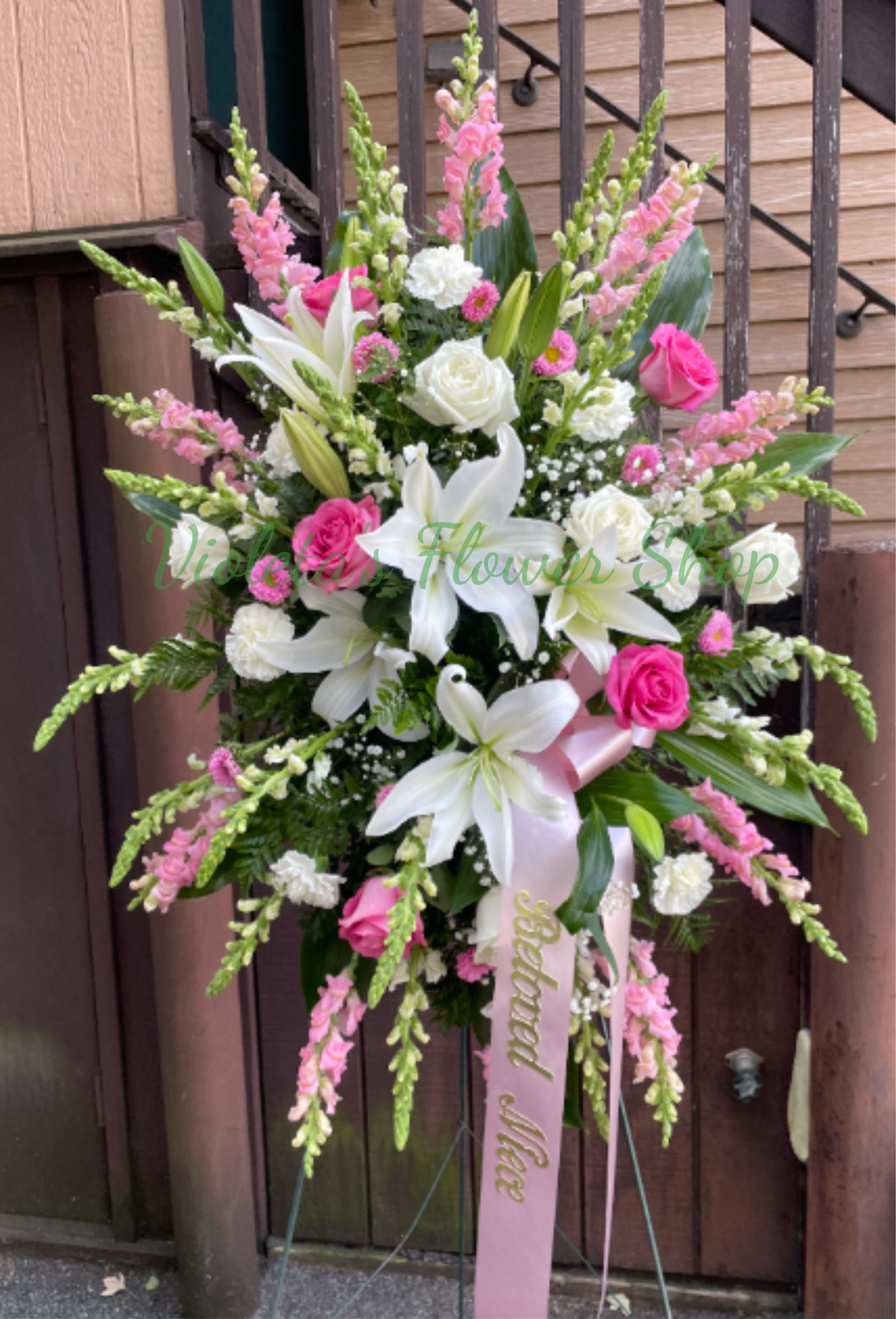 Tall pink and white floral standing spray with lilies and roses