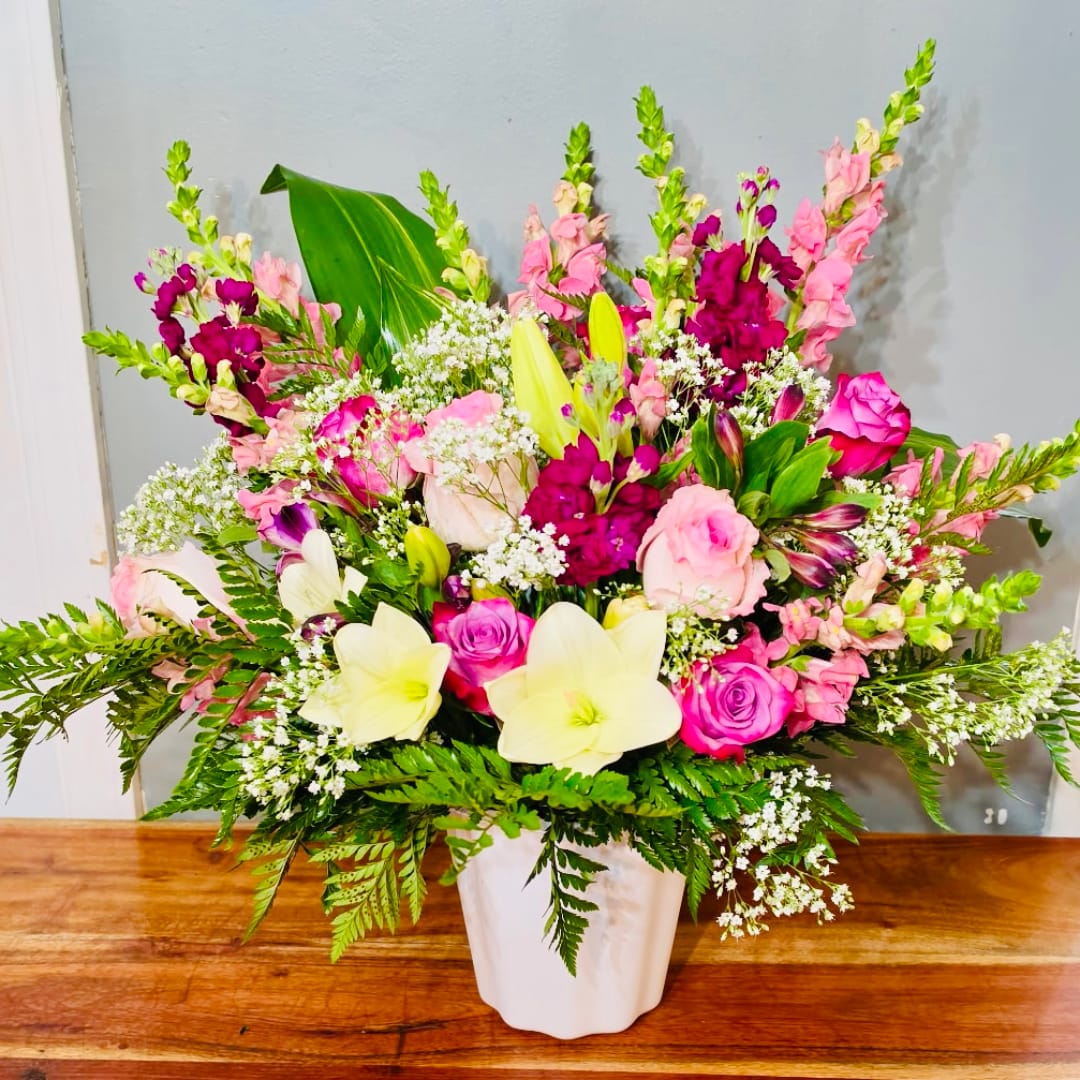 Pink and white mixed flower arrangement in a white vase