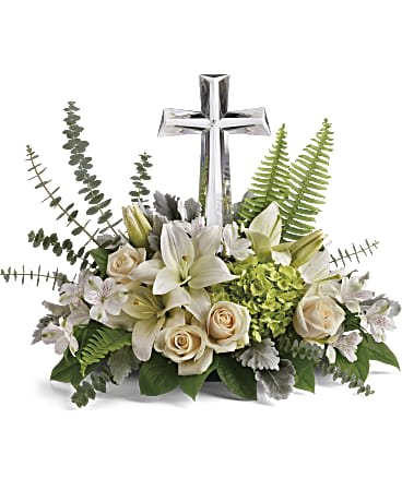 White floral arrangement with a silver cross centerpiece