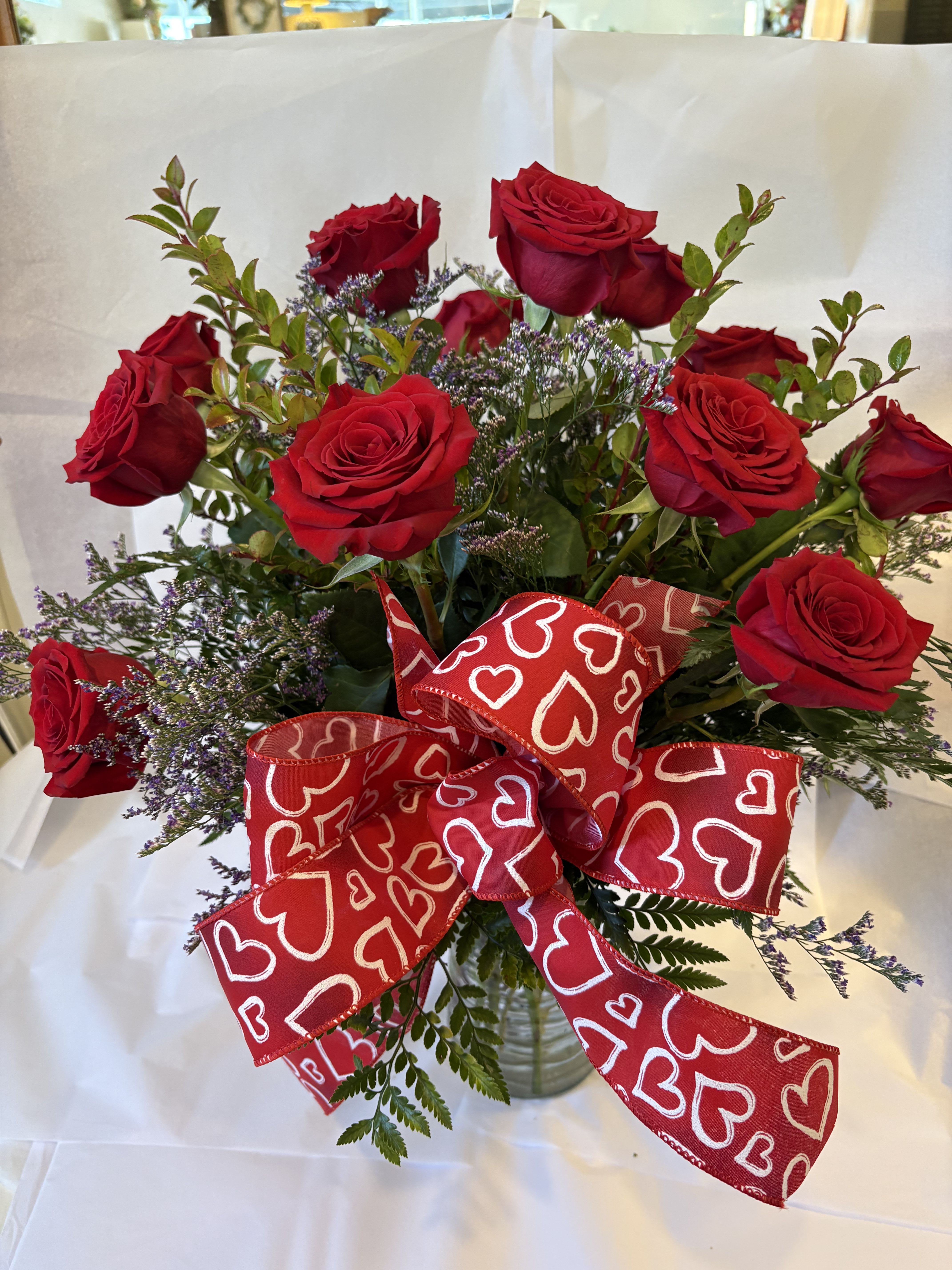 A Dozen Premium Red Roses - For classic romance a dozen red roses is always the perfect choice. One dozen long-stemmed red roses in a clear glass vase.Approximately 20" W x 24" H Orientation: All-Around As Shown : TF31-1