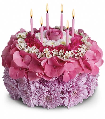 Your Special Day - Tell the birthday girl to make a wish on these candles! Made entirely of fresh flowers this delightful "cake" will really make her day special. The recipe for this cake includes a pink rose and hydrangea hot pink miniature carnations white button spray chrysanthemums and waxflower and lavender cushion spray chrysanthemums. This tasteful arrangement even comes with its own hot pink candles. It's everything a girl could wish for!Approximately 10" W x 10" H Orientation: All-Around As Shown : T16-3ADeluxe : T16-3BPremium : T16-3C