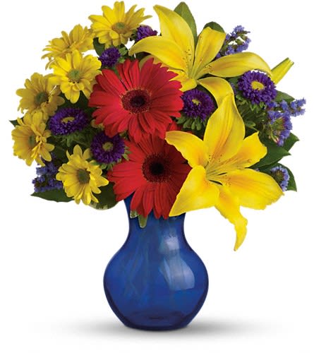 Teleflora's Summer Daydream Bouquet - Send them on a summer daydream with this sensationally sunny bouquet! These vivid blooms are arranged in a cobalt blue vase. Includes yellow asiatic lilies red gerberas purple matsumoto asters yellow daisies lavender statice and fresh green lemon leaf. Delivered in a Serendipity vase.Approximately 13" W x 14 1/2" H Orientation: One-Sided As Shown : TEV31-4ADeluxe : TEV31-4BPremium : TEV31-4C