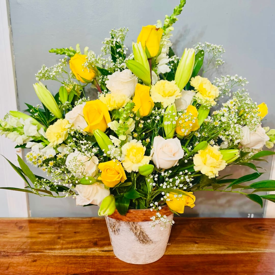 Yellow and white rose bouquet in a rustic pot
