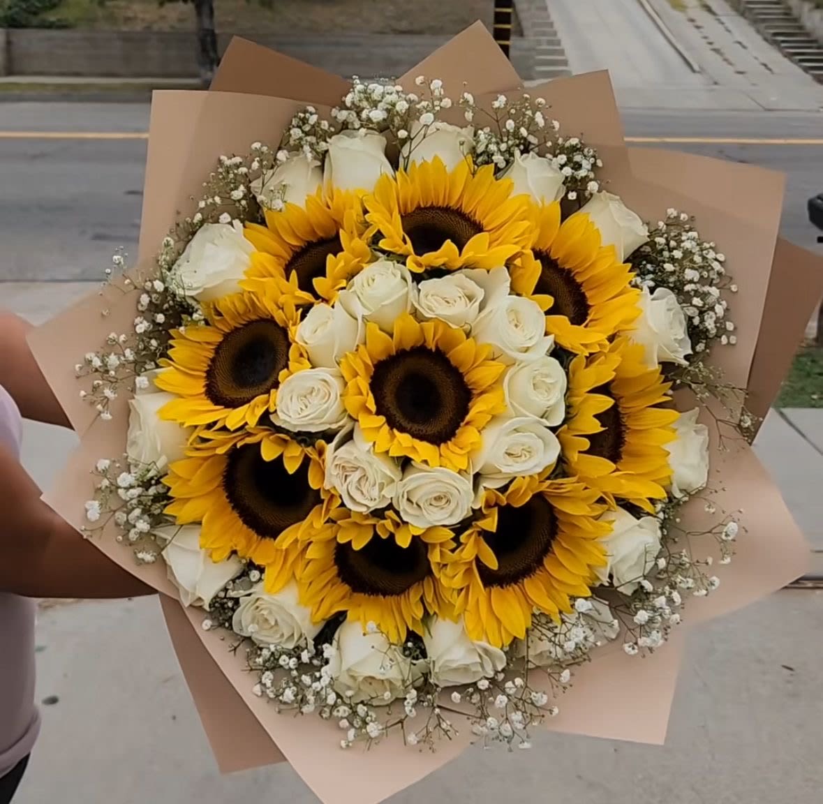 Sunflower &amp; White Rose Harmony Bouquet - A radiant mix of bright sunflowers and elegant white roses designed to bring warmth, positivity, and joy to any celebration. Surrounded by delicate baby’s breath and wrapped in soft beige tones, this bouquet delivers sunshine in its purest form — a perfect gift for birthdays, anniversaries, or simply “just because.”