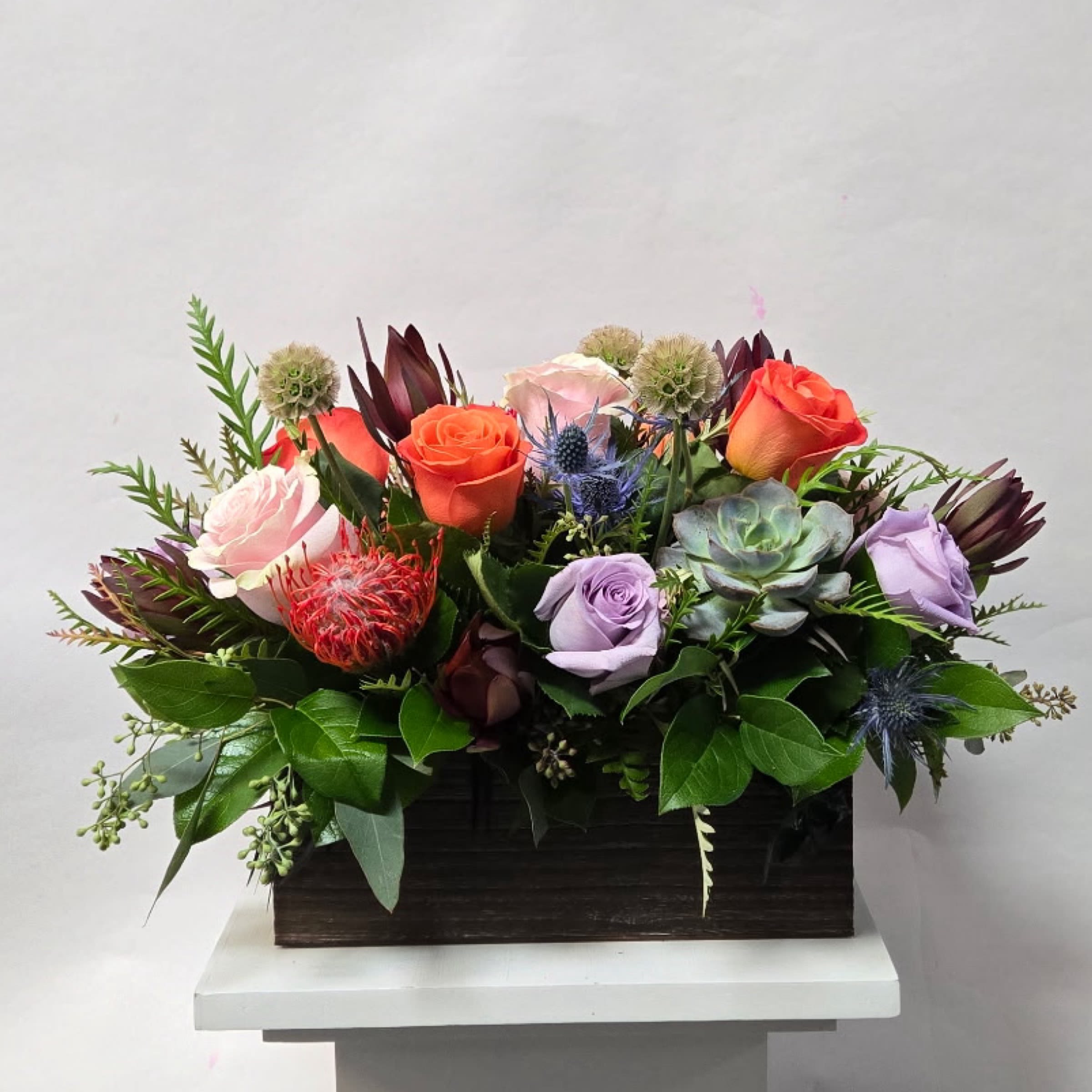 In the Meadows - A Low and Airy Bright Spring Mixed Centerpiece in a Rectangular Wooden Box. 