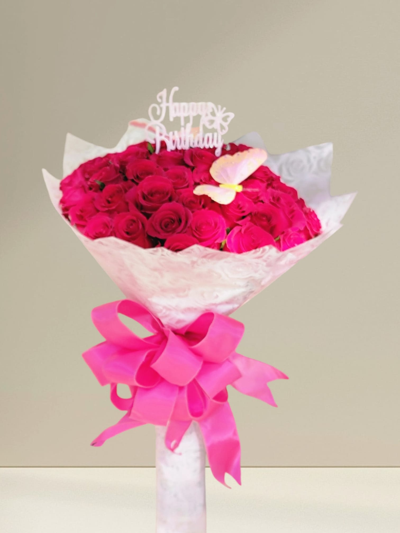 Bouquet of hot pink roses with a birthday topper and ribbon
