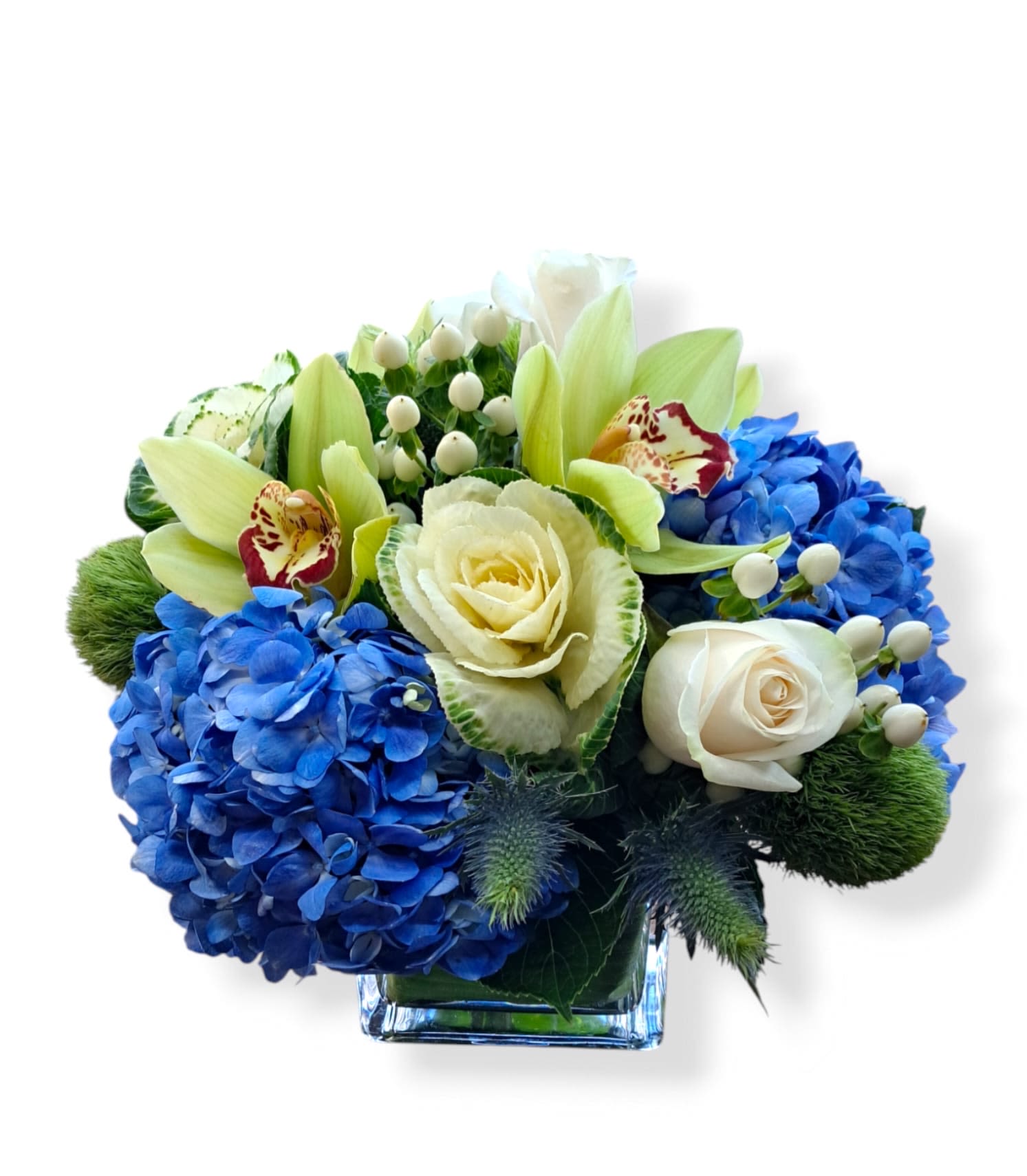 Blue hydrangeas and white roses in a square glass vase