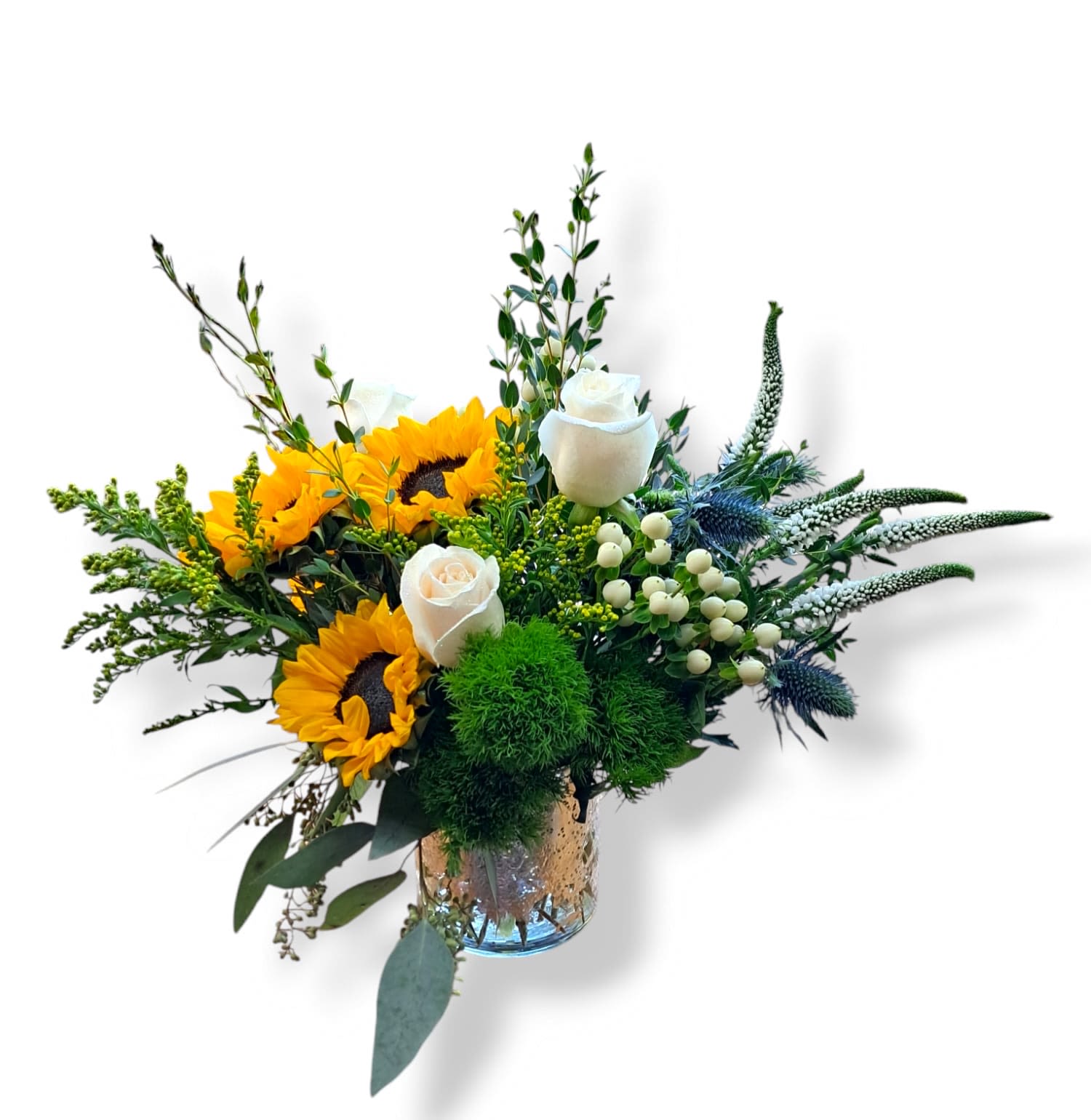 Sunflowers and white roses in a glass vase with greenery