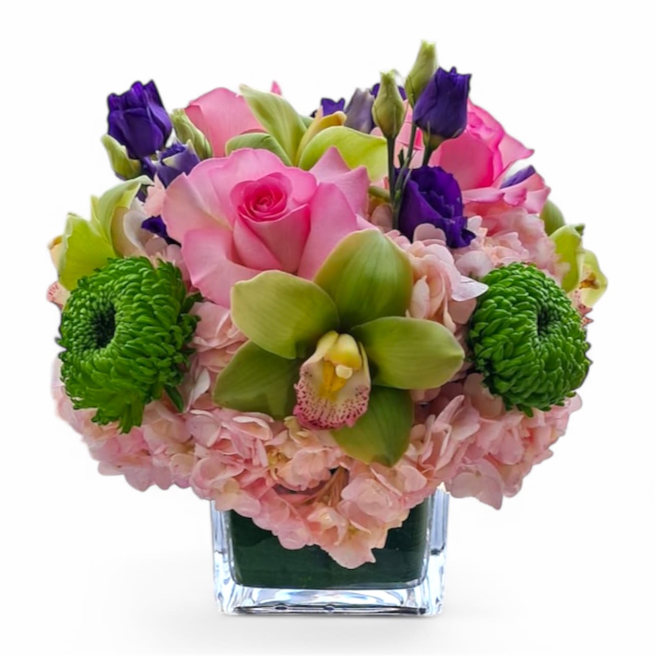 Pink roses and green orchids in a clear square vase