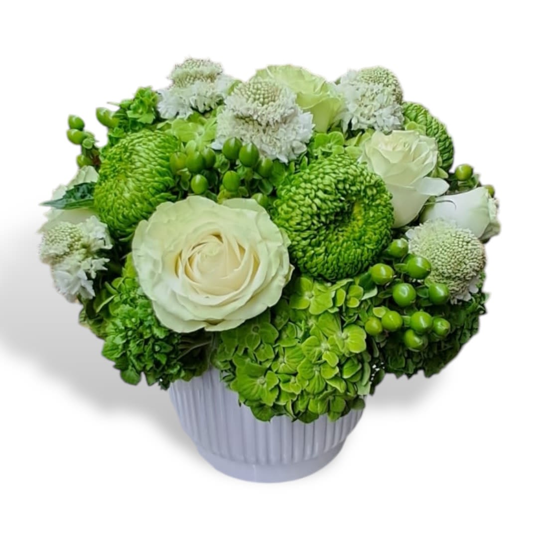Green and white floral arrangement in a ribbed vase