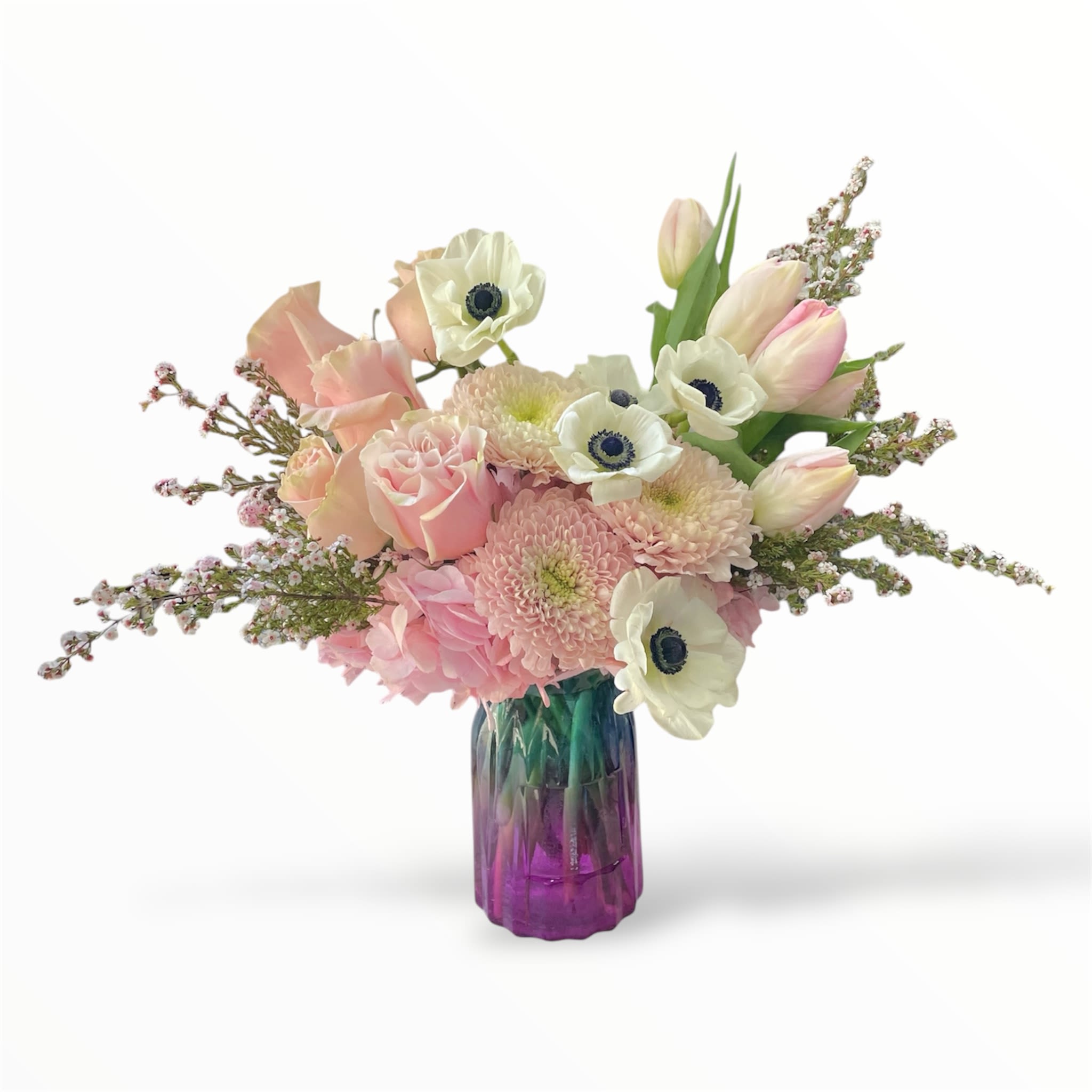 Pink and white bouquet in a purple glass vase