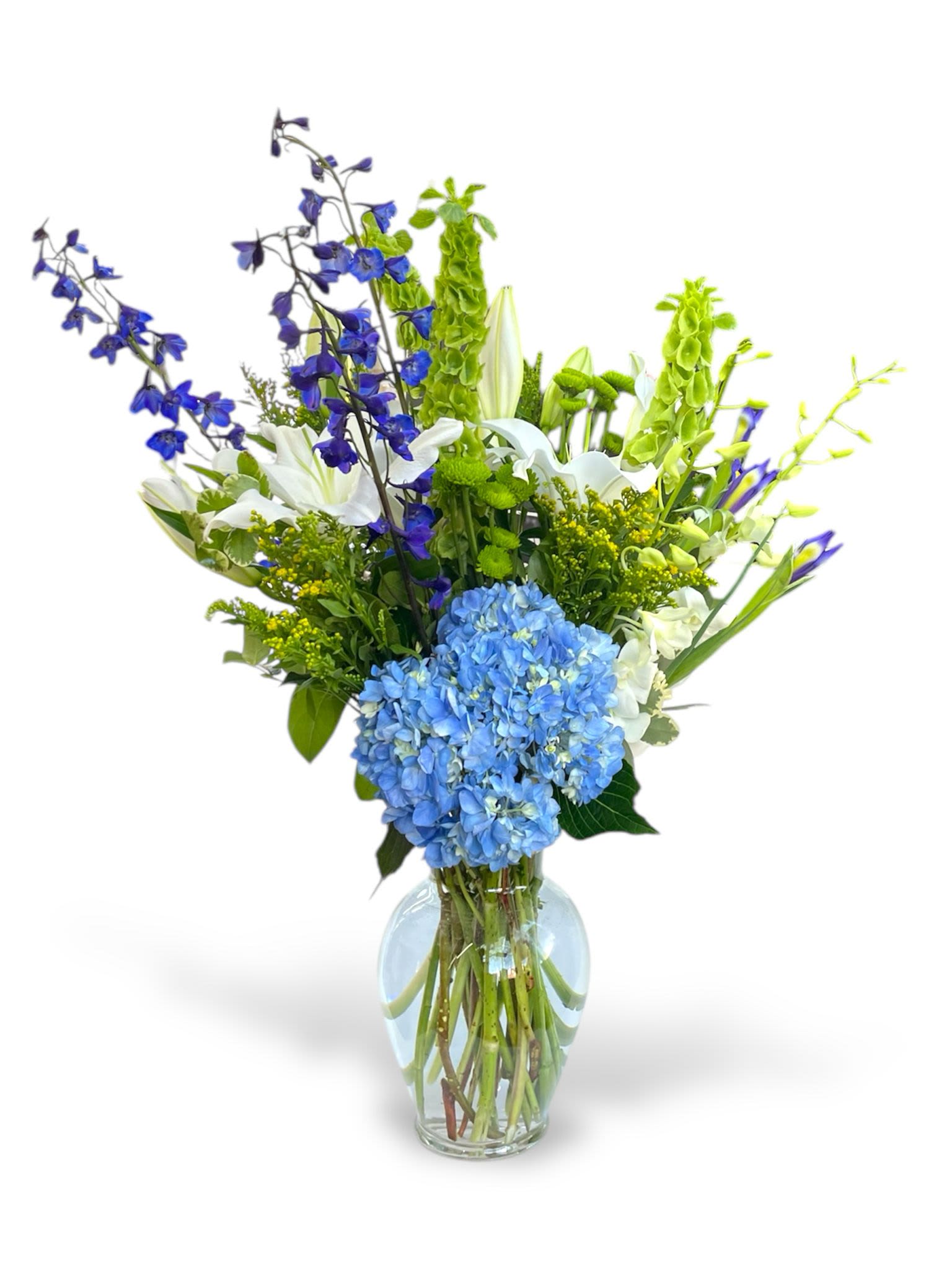 Blue and white mixed flower arrangement in a clear glass vase