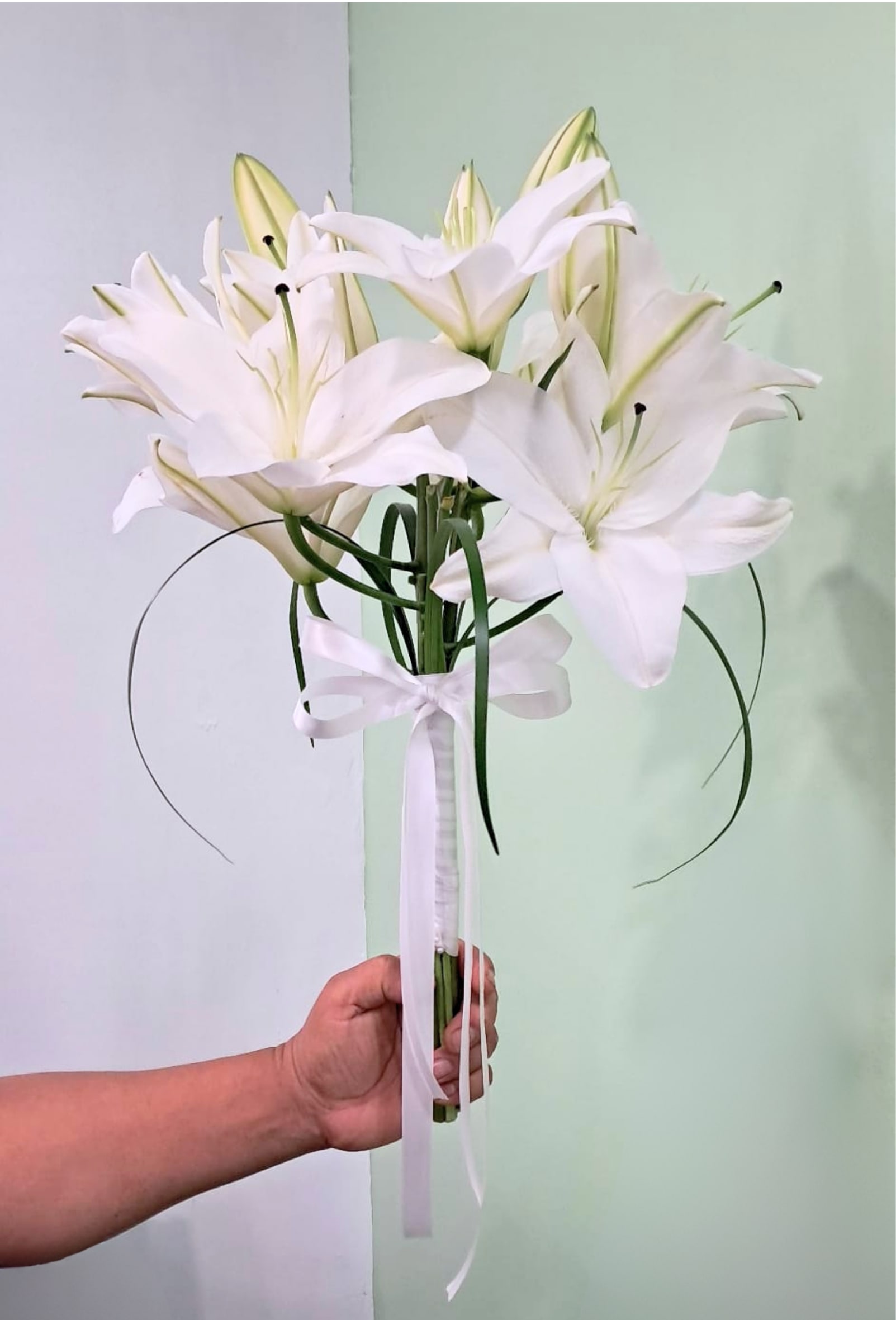 White lily bouquet tied with a white ribbon