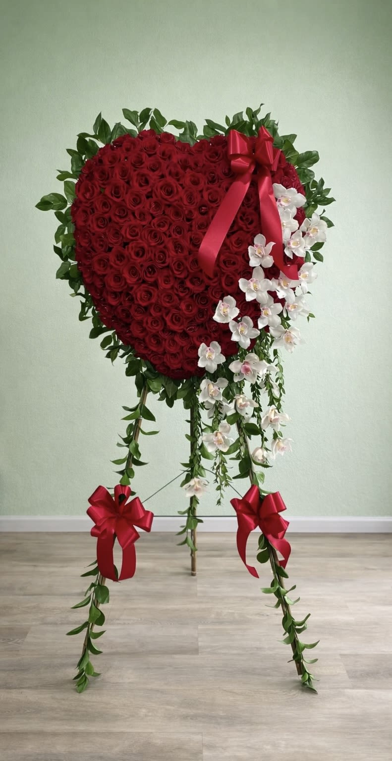 Deep &amp; Heartfelt Love Spray - This beautiful heart spray combines classic red roses with elegant white orchids to create a meaningful tribute that truly speaks from the heart.