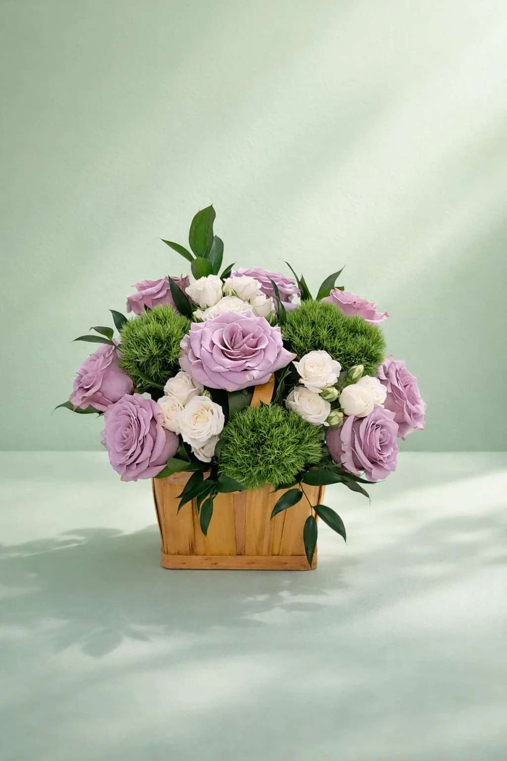 Lavender Harmony - Soft lavender roses, clean white blooms, and fun pops of green in a sweet wooden basket.