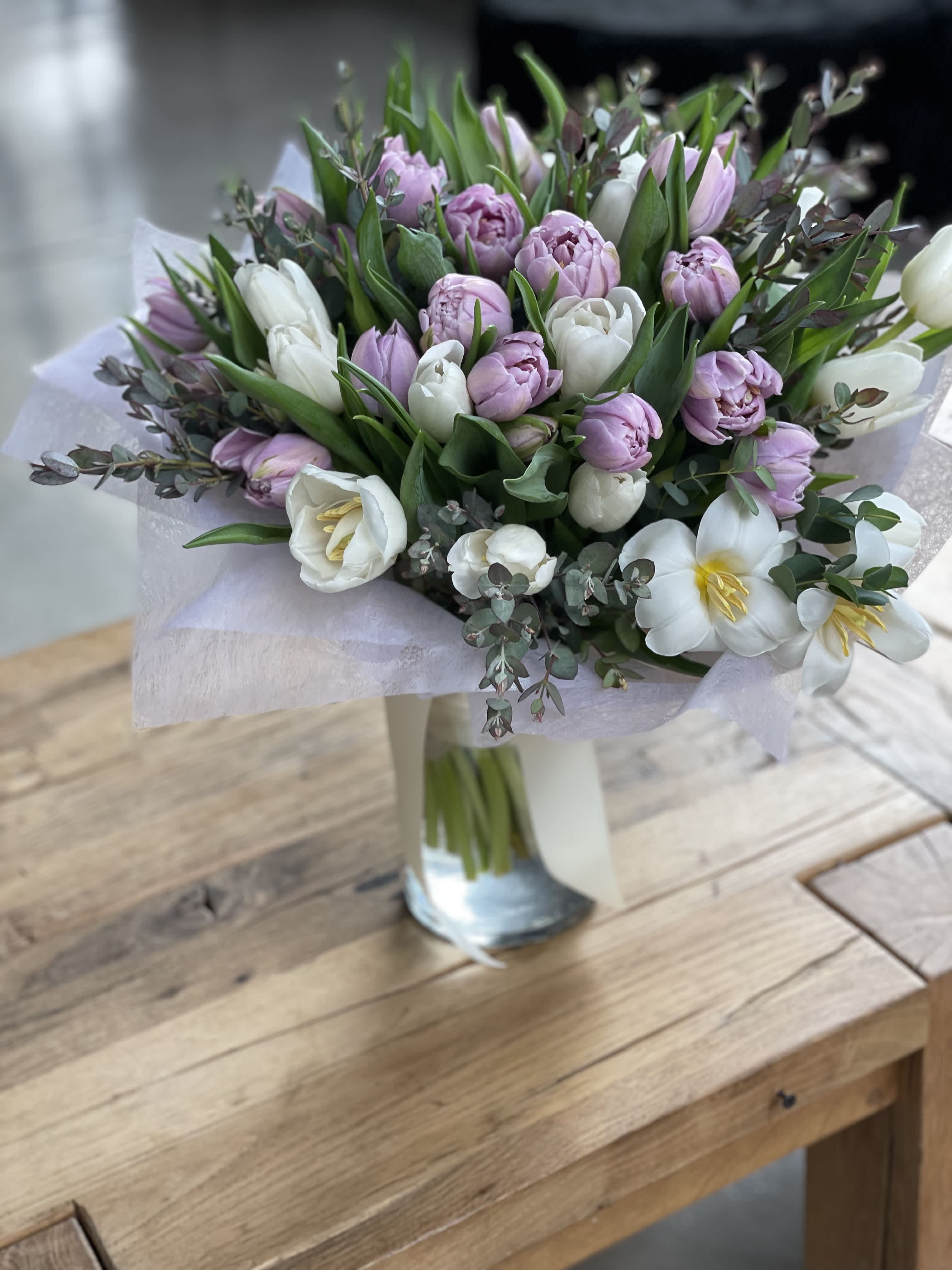 Bouquet of pink and white tulips in a glass vase