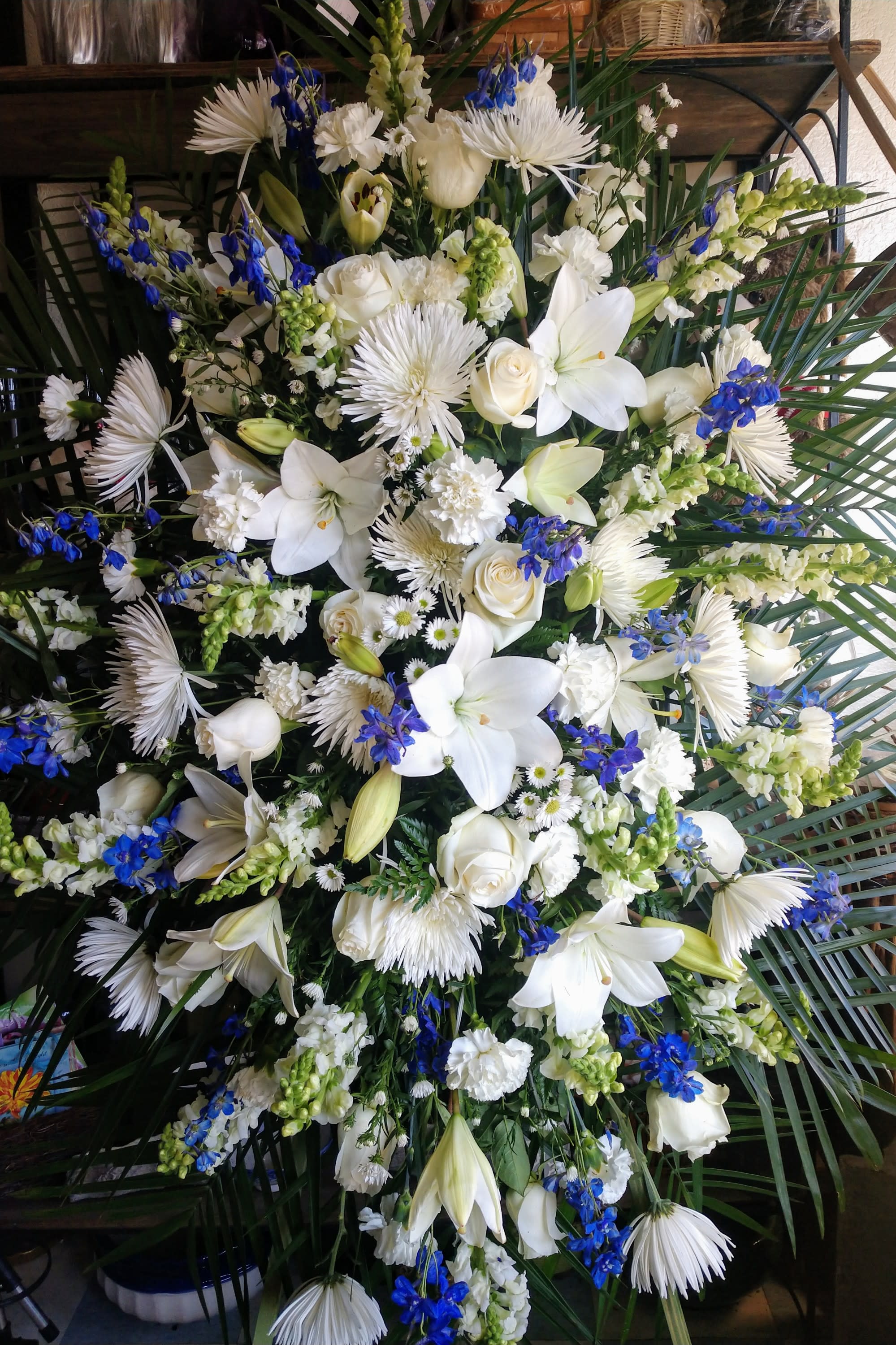 Large white and blue floral spray with lilies and roses