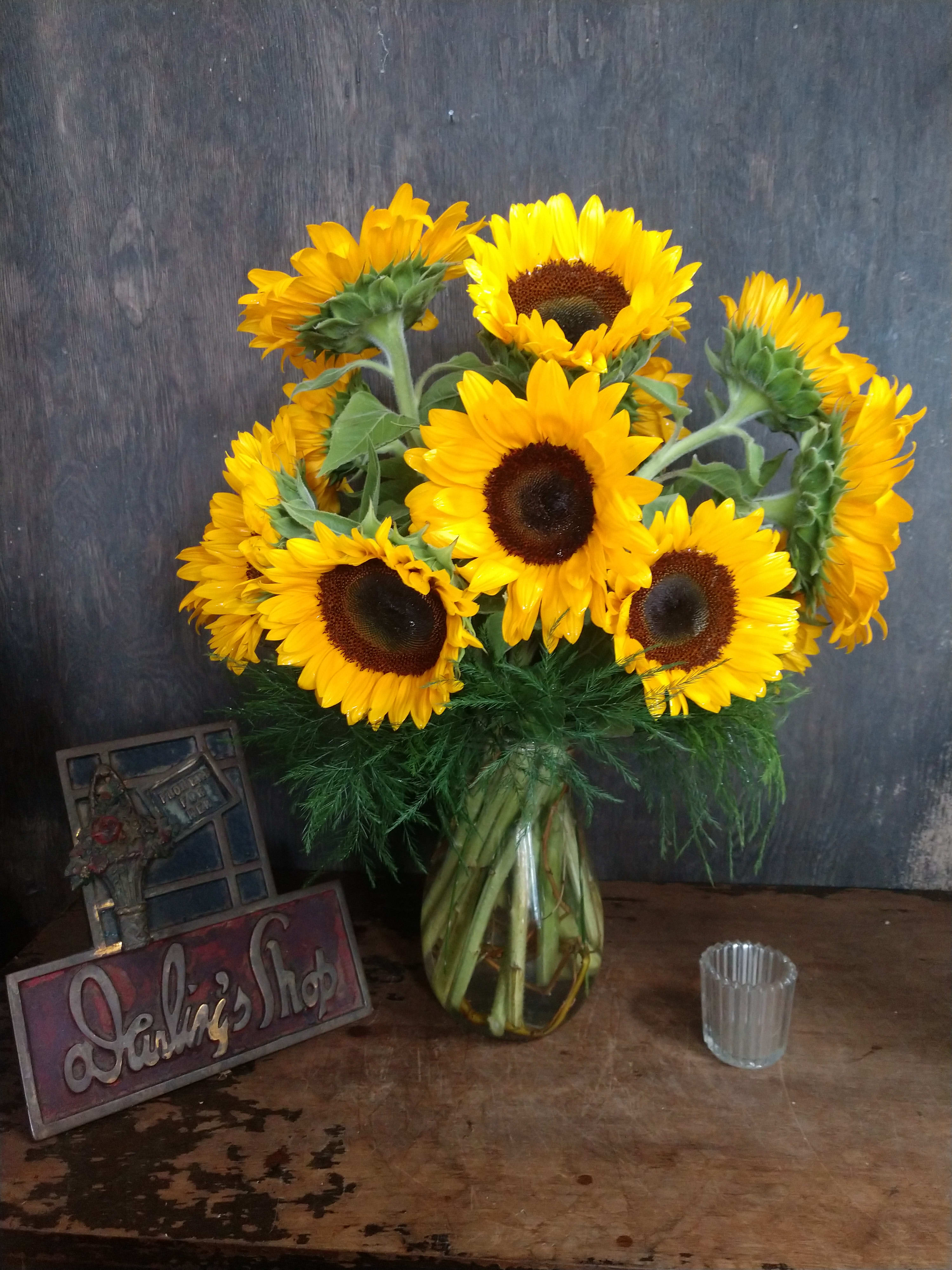 Bouquet of yellow sunflowers in a glass vase