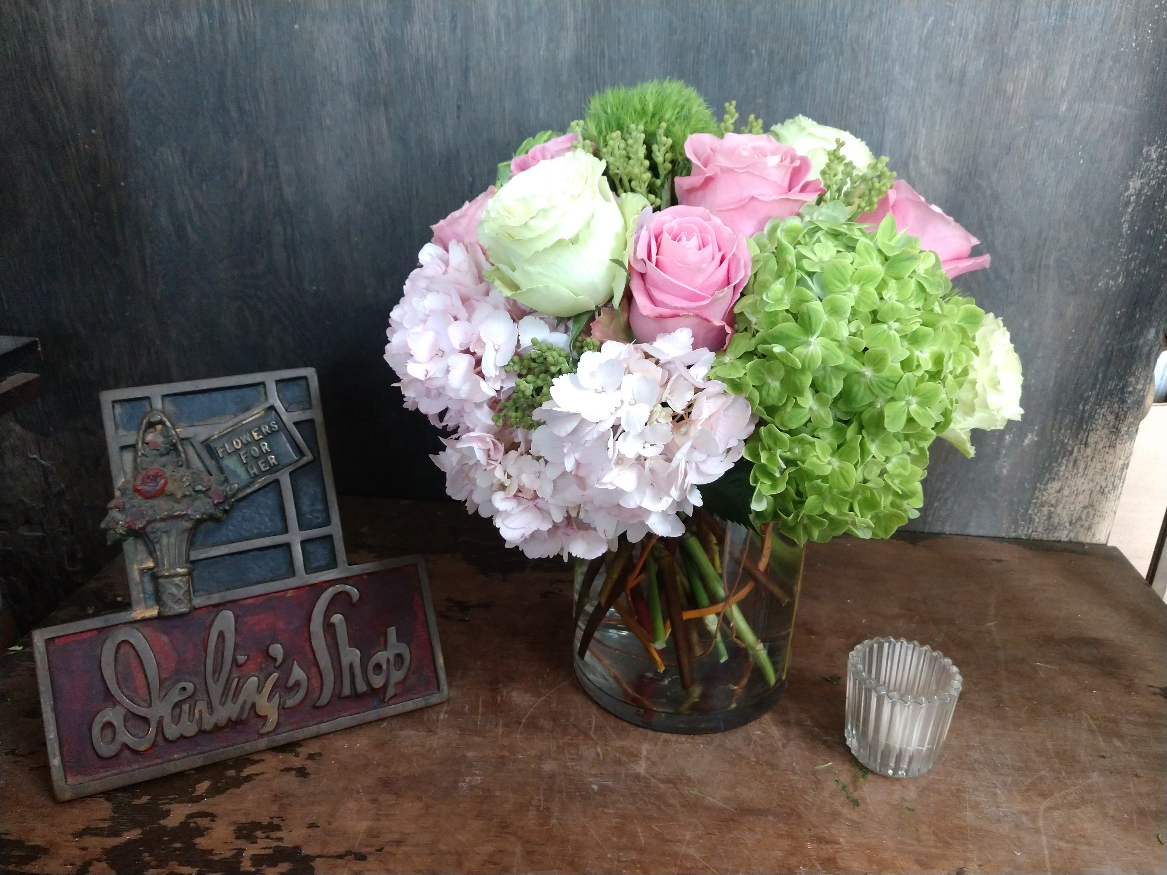 Pink and white roses with hydrangeas in a glass vase