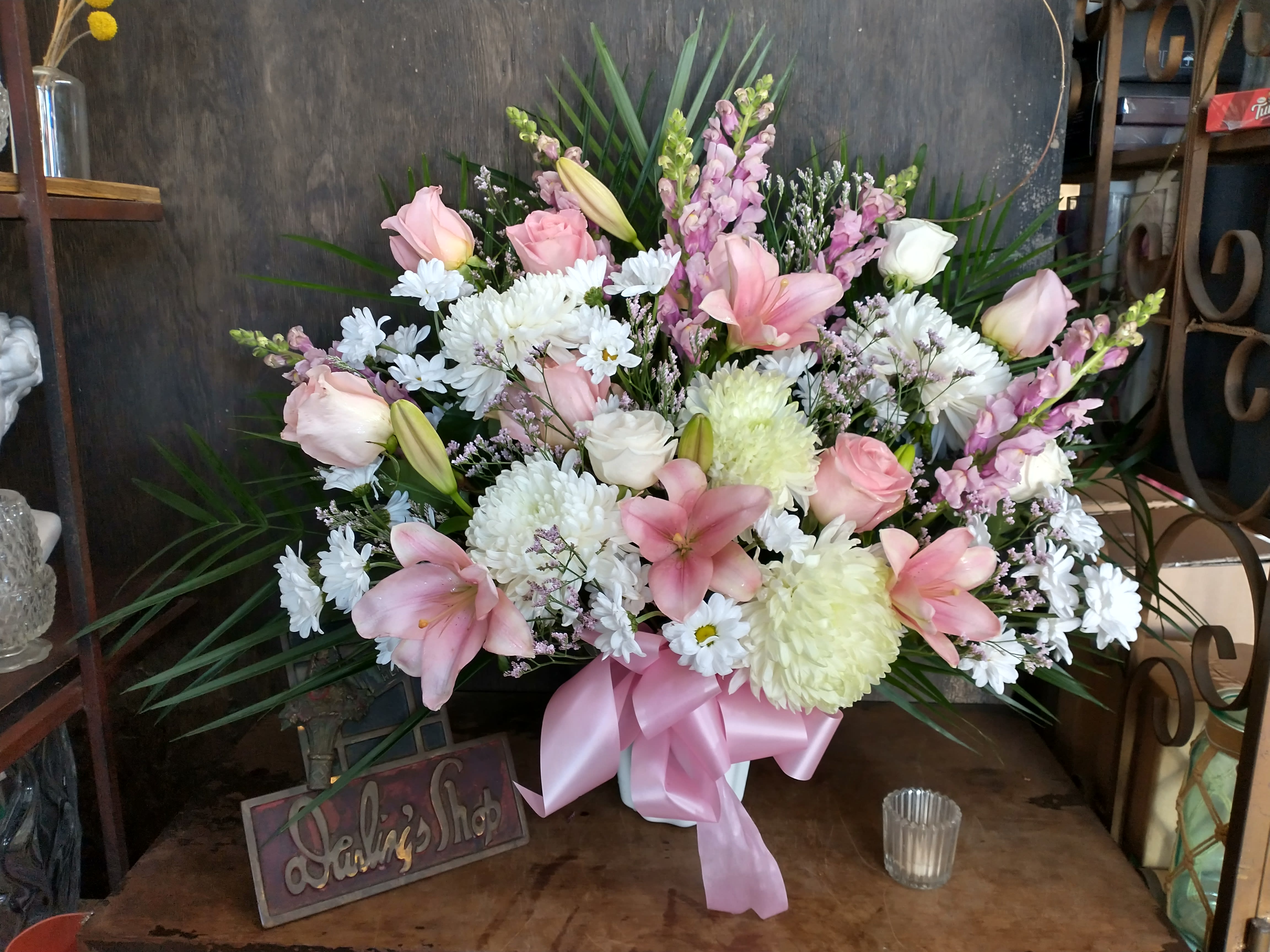 Pink and white mixed flower arrangement with a pink ribbon