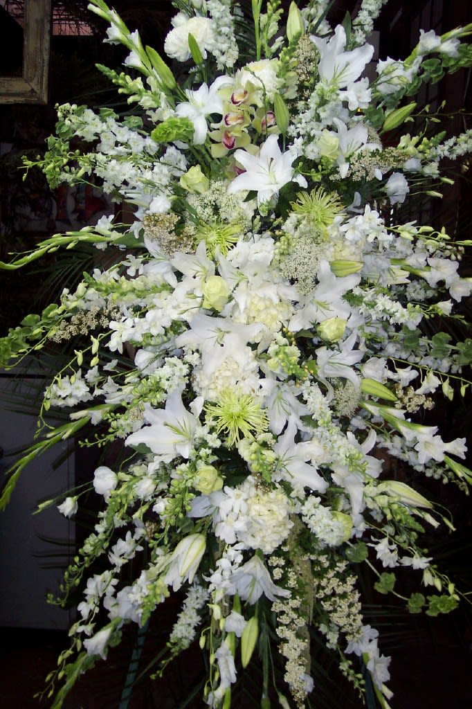 Large white floral spray with lilies and orchids
