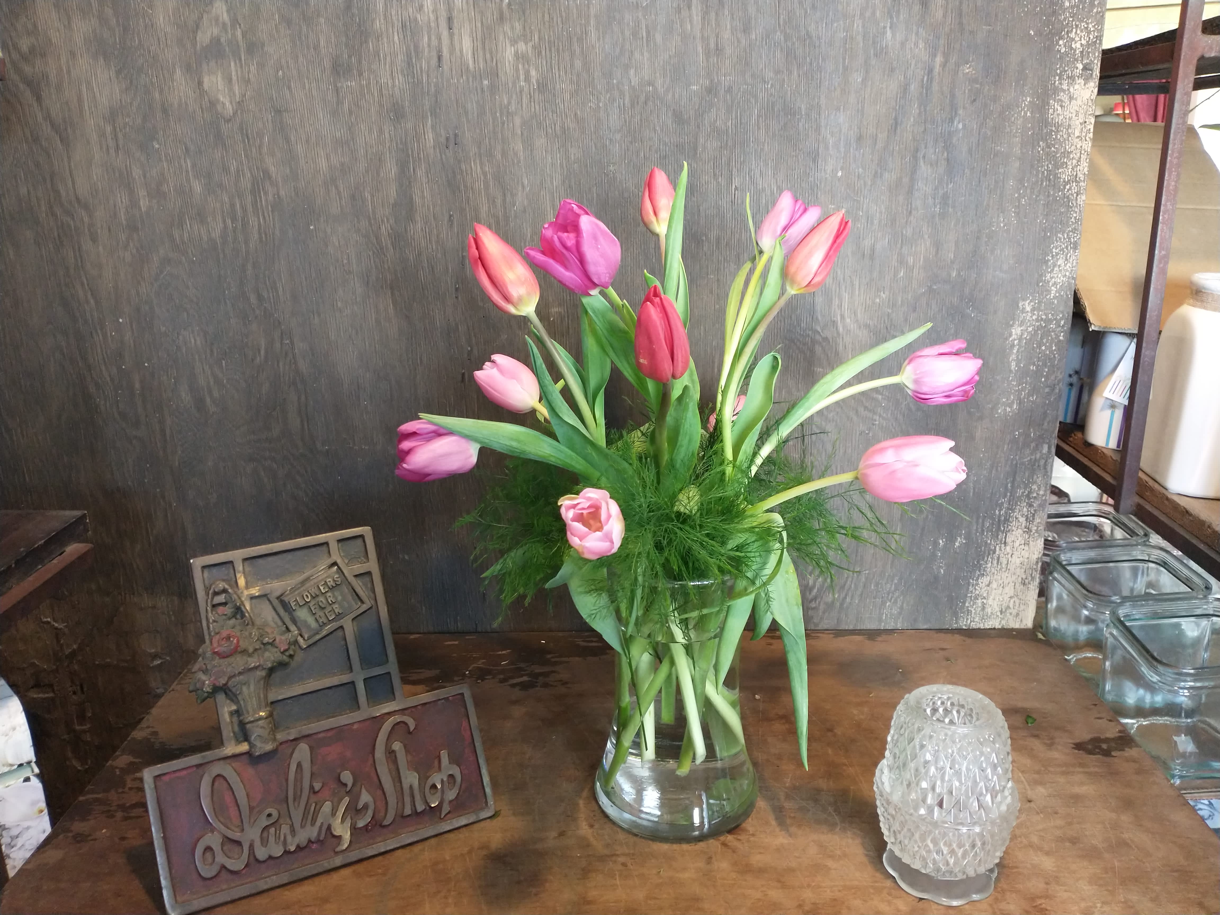 Pink and purple tulips in a clear glass vase