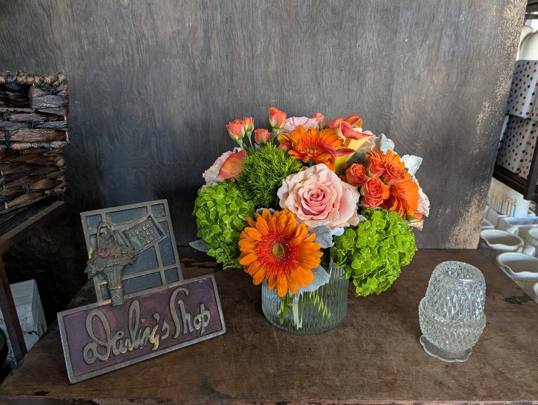Bouquet of orange and pink flowers in a glass vase