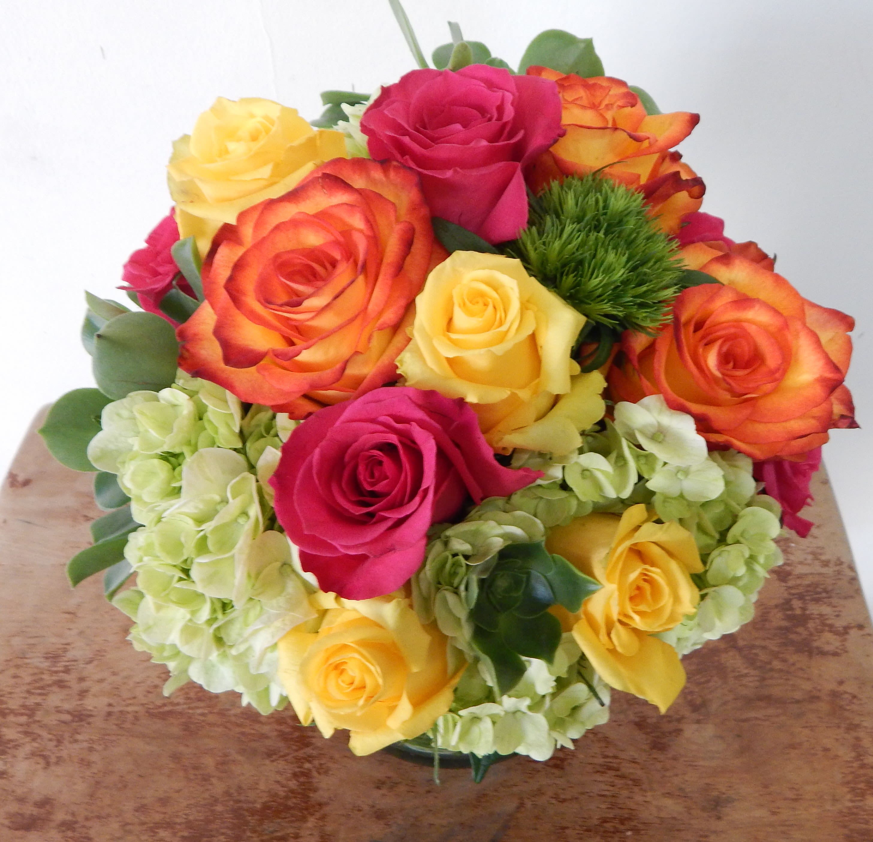 Bouquet of multicolored roses with pale hydrangeas