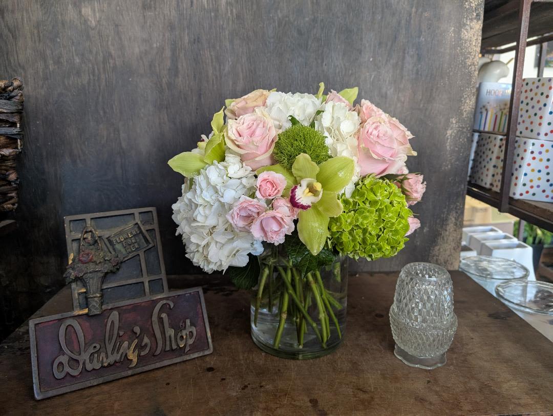 Pink and white flower arrangement in a glass vase