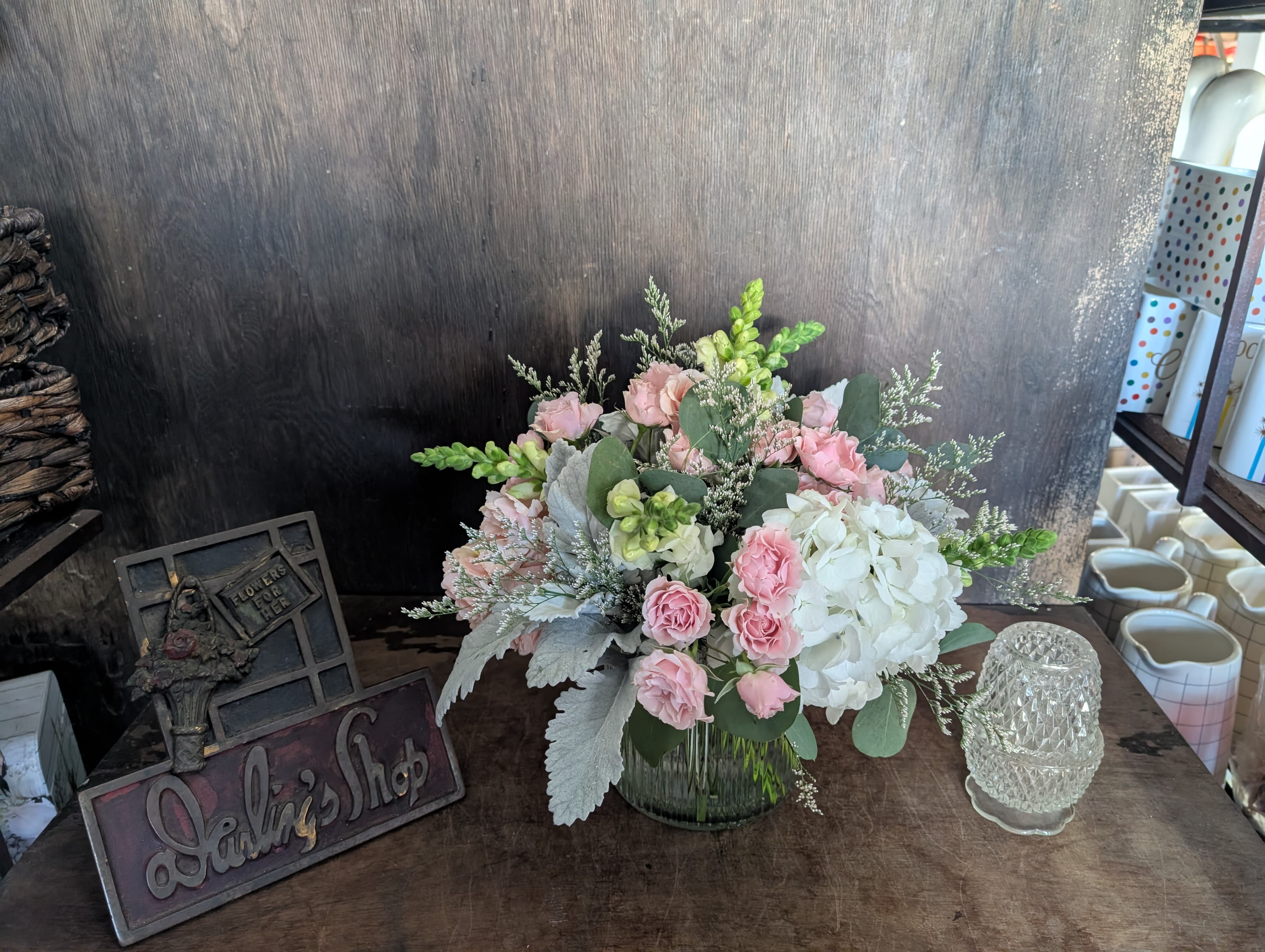 Pink and white floral arrangement in a glass vase