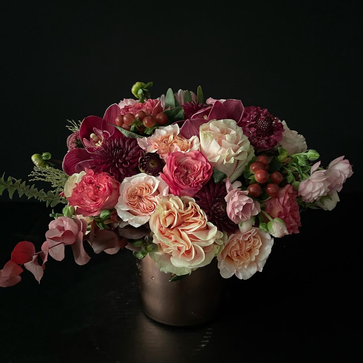 Mixed pink and cream bouquet in a dark vase