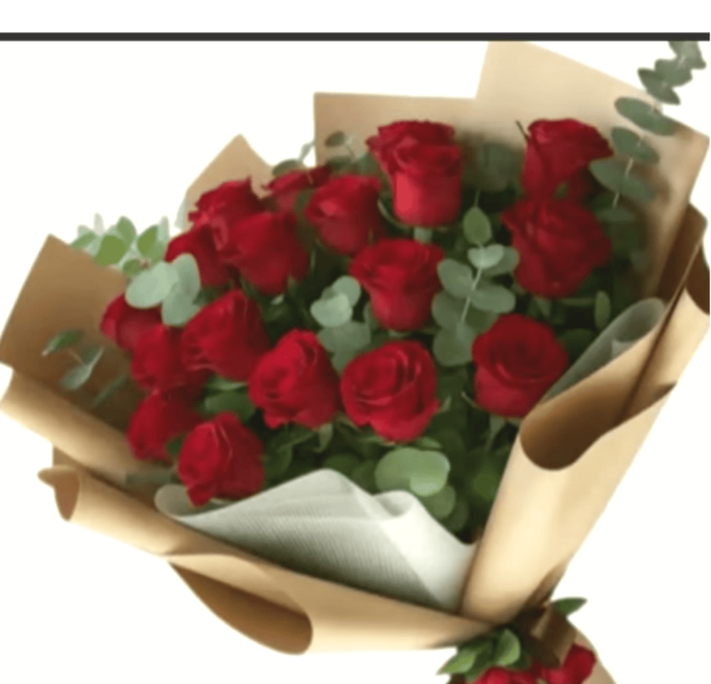 Bouquet of red roses wrapped in brown paper