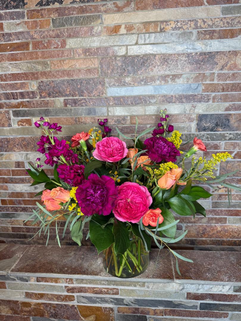 Bouquet of pink and orange flowers in a glass vase