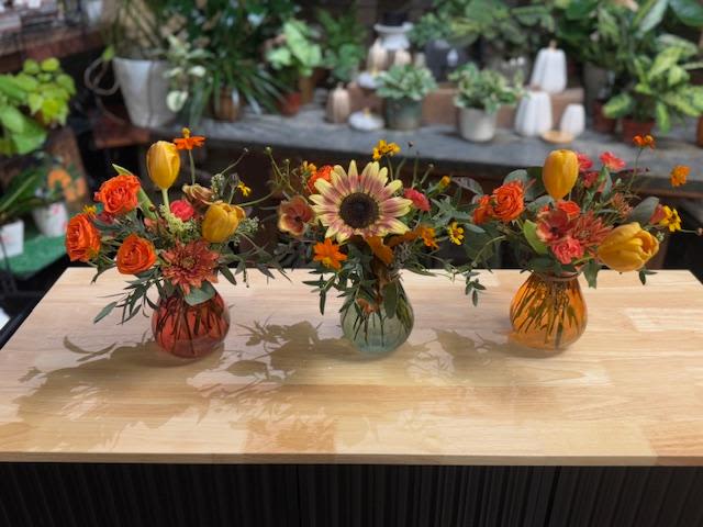 Autumn Trio - Three small mixed color bud vases with seasonal autumn blooms are the perfect choice to bring home for Thanksgiving or any fall get together! They can be clustered together or spread out with candles and other decor to make the finishing touch on your holiday dining table. 