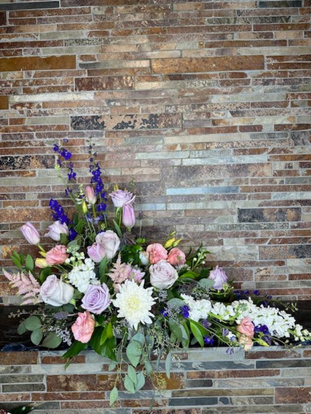 Large floral arrangement with pink, white, and purple blooms