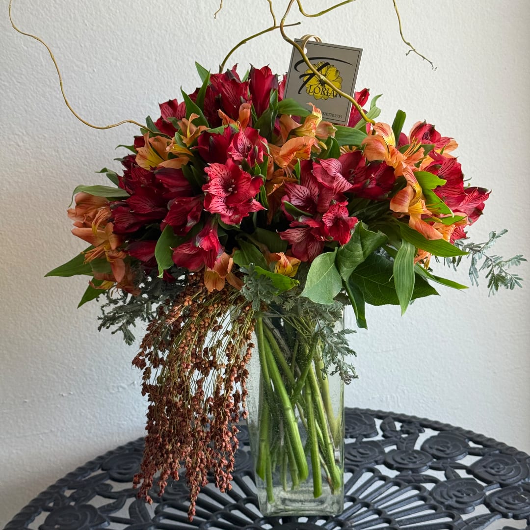 Bouquet of red and orange flowers in a clear glass vase